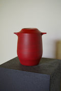 Handmade red stoneware vase by Naeos — bold earthy glaze, sculptural luxury ceramic homeware