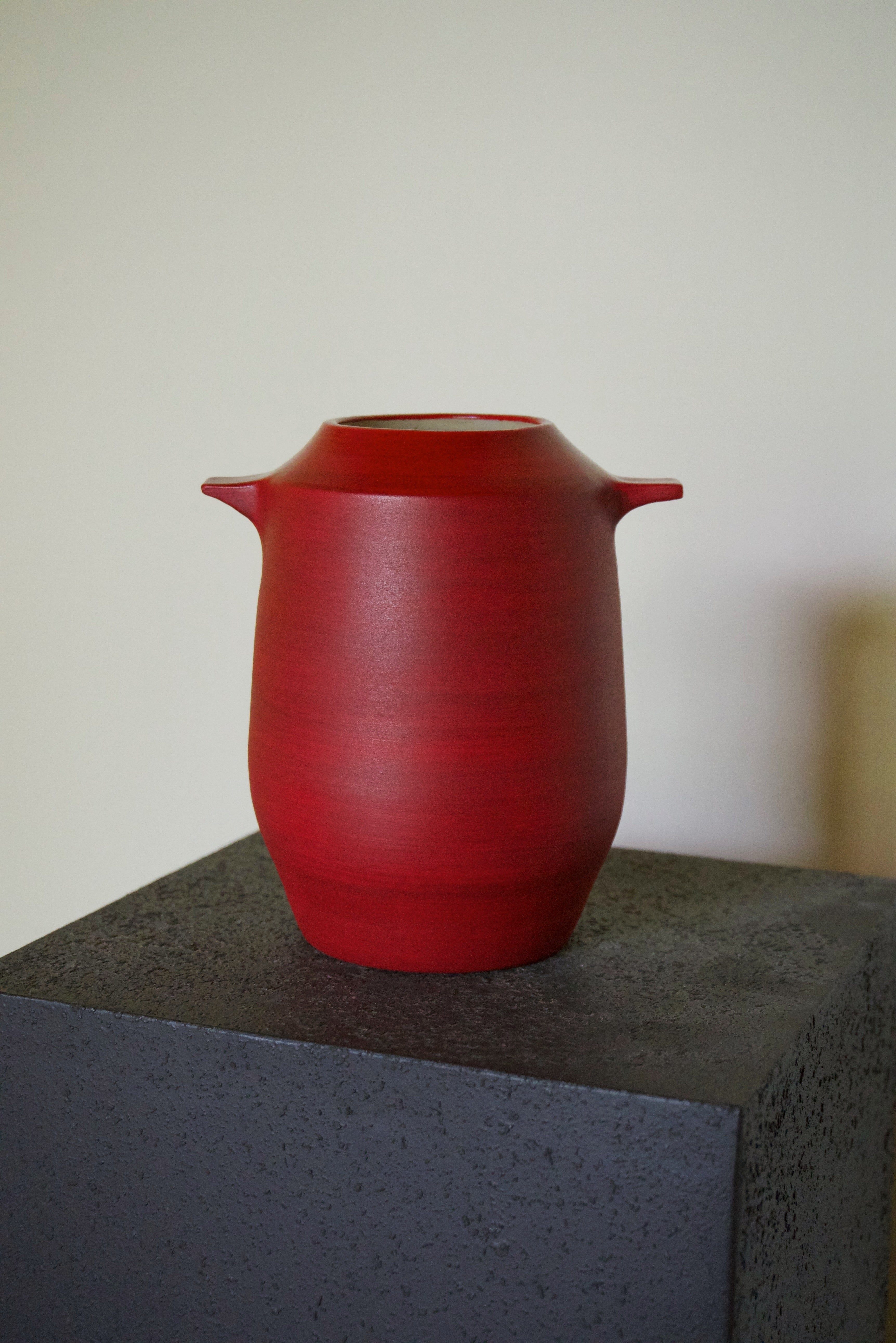 Handmade red stoneware vase by Naeos — bold earthy glaze, sculptural luxury ceramic homeware